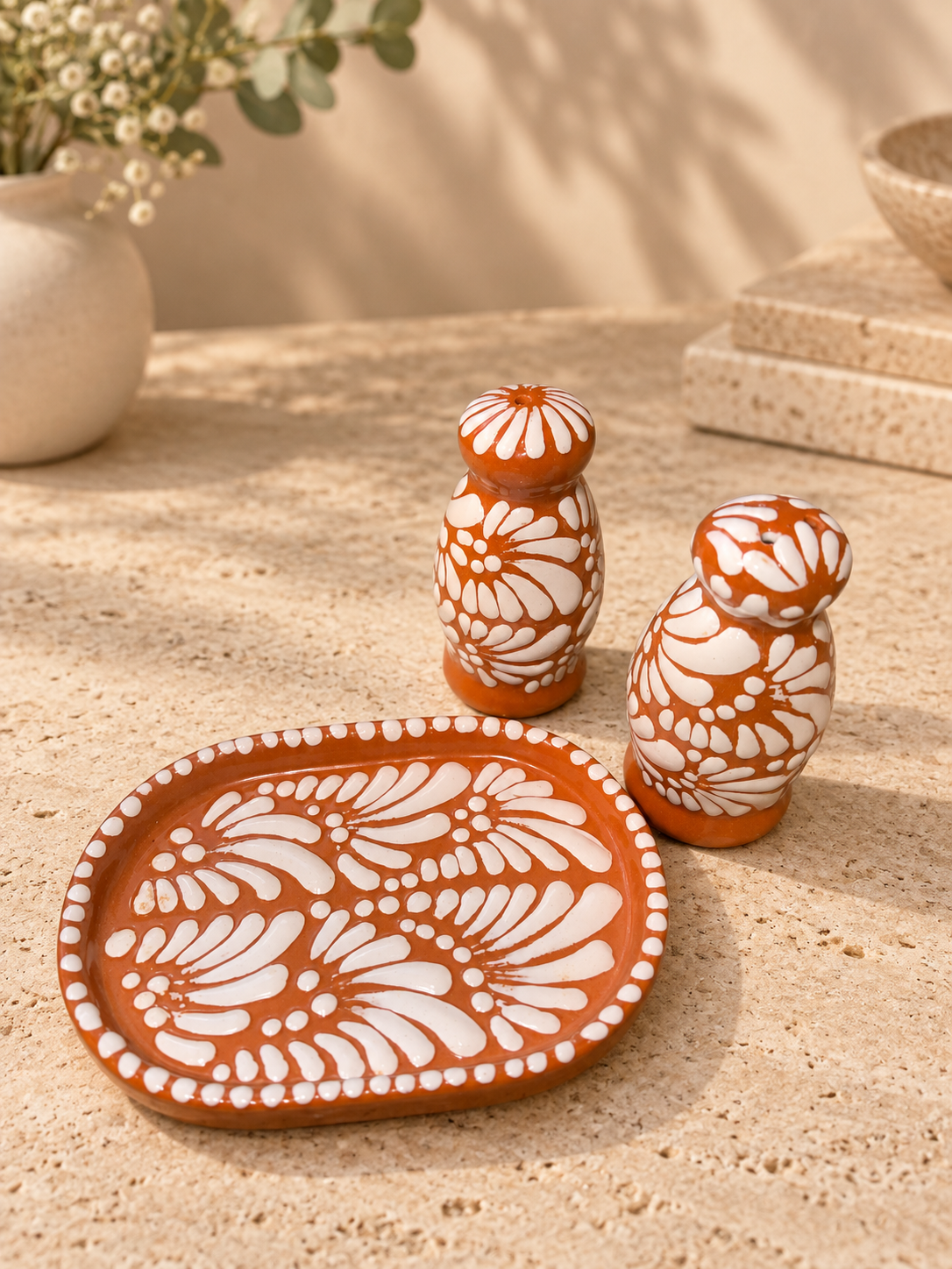 Brown and white salt and pepper shakers with plate