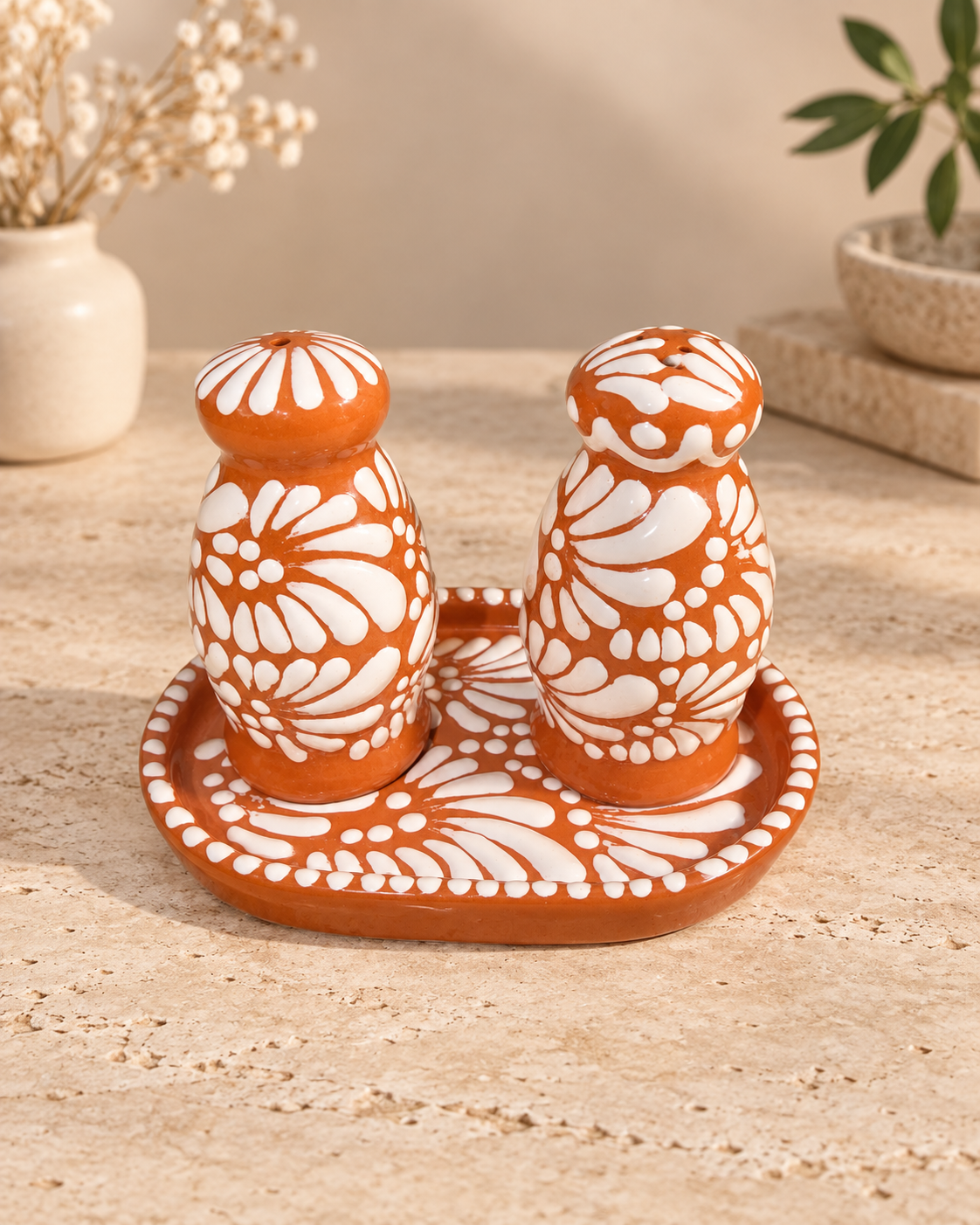Brown and white salt and pepper shakers with plate